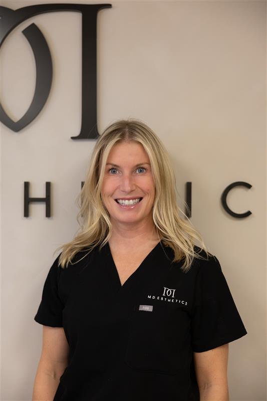 Alisha, team member at MD Esthetics, professional headshot in front of the MD Esthetics logo.