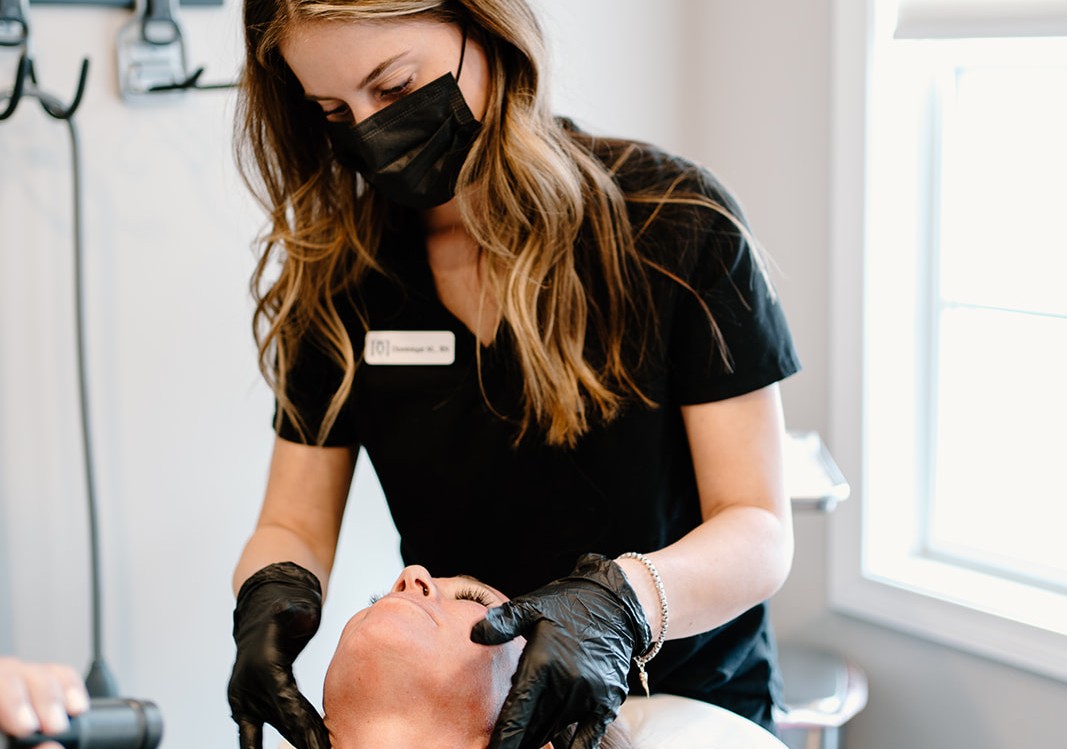 Aesthetic practitioner administering Botox injections to a patient’s forehead, illustrating the procedure discussed in the ultimate guide to Botox treatments.